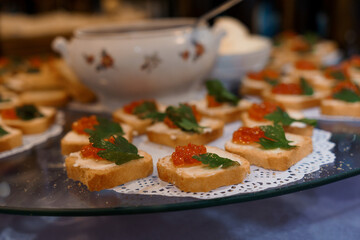Elegant Appetizer Platter Featuring Cream Cheese, Salmon Roe, and Fresh Herbs on Toasted Bread