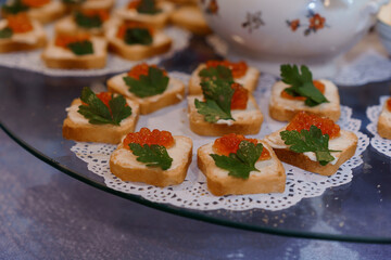 Elegant Canapes with Caviar and Fresh Herbs on a Decorative Platter