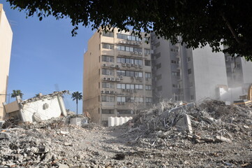 Fototapeta premium Excavators at Building Demolition Site with Rubble and Debris 