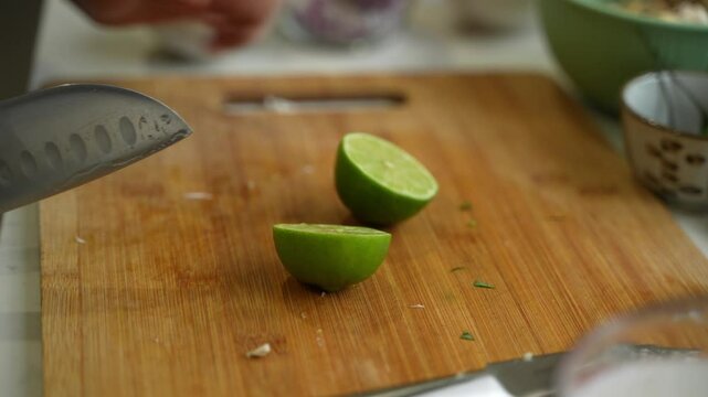 Cutting of green lemon on two halves. Closeup view.