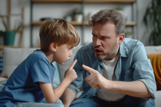 Father calmly addresses son about his behavior during a serious conversation at home in the afternoon