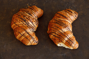 Croissant with butter two pieces on a black board. High quality photo