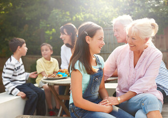 Outdoor, grandma and child with laughing for love, connection and bonding together with lunch. Happy people, senior woman and girl with smile for care embrace, security and trust for brunch snack