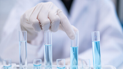 Closeup test tube equipment filling with blue liquid in laboratory room use for science chemistry biology biotechnology medical medicine biochemistry research and development discovery education