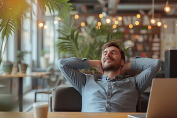 Obraz premium A relaxed man enjoying a moment of tranquility in a modern café with greenery and soft lighting during the afternoon