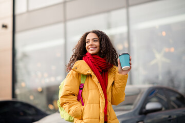 Photo of cheerful positive cute girl wear jacket walk downtown drink hot tea cacao weekend cold autumn day outdoors outside