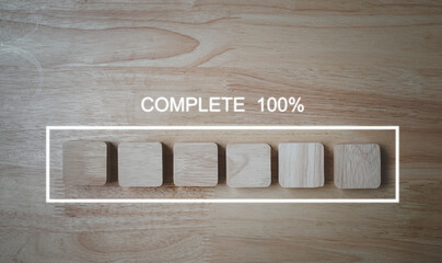 Processing is 100% complete, The work process is complete, wooden blocks lined up on a wood background.