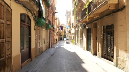 Cleaning service working on a street in Barcelona in the neighborhood of Gracia, Catalonia, Spain. Moving shot. Bcneta.