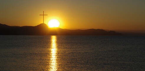 luminous cross in the skyover the sea at sunset or sunrise. Biblical scene, concept of Holy Scriptures of Old and New Testaments, Christian religion