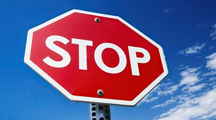 Obraz premium Close-up of a stop sign with bright red color and white lettering, against a blue sky with a few scattered clouds in the background. --chaos