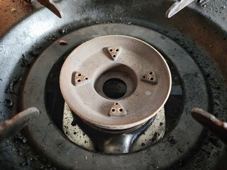 The gas burner is turned off in the kitchen,dirty black gas burner