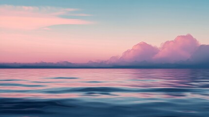 Obraz premium Pink and blue sunset over calm water with clouds.