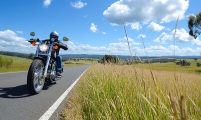 Obraz premium Motorcyclist riding on a country road.