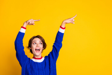 Photo portrait of attractive young woman point funky empty space dressed stylish blue knitted...