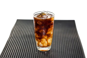 Americano ice coffee serving on bar mat with isolated concept.