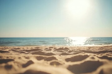 Fototapeta premium Serene beach landscape with golden sand and sparkling ocean under a bright sun, capturing the essence of a peaceful summer day by the sea.