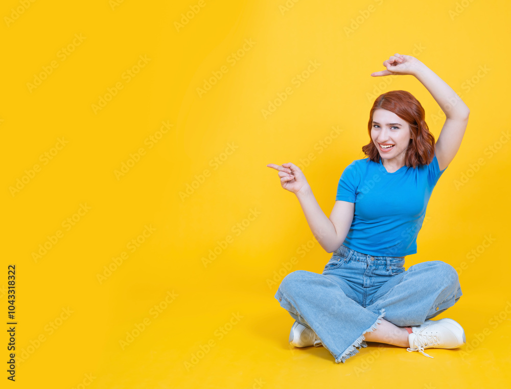 Wall mural pointing aside, full body studio shot of young caucasian red bob hair attractive young woman pointin