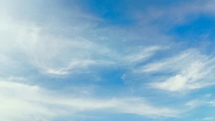 The blue sky is decorated with dense clouds that spread out on a sunny day. Sky background. Nature Background.