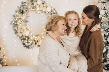 Three Generations Smiling Together During Holiday Season