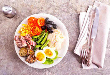 breakfast with boiled eggs, meat and vegetables