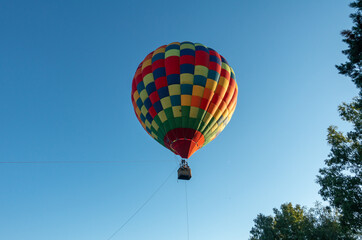 Fototapeta premium Colorful Muticolor hot air balloon floting in the blue sky.