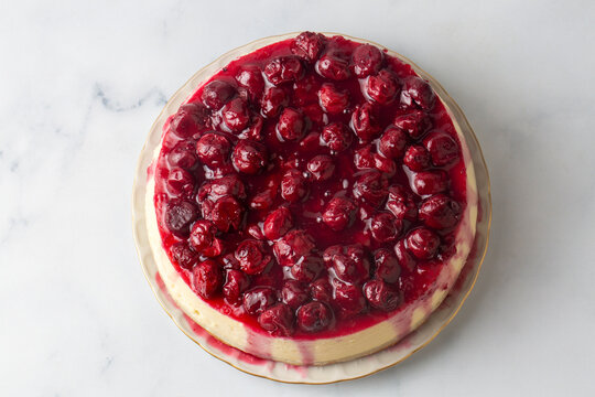 Fresh baked cheesecake with a cherry berry topping