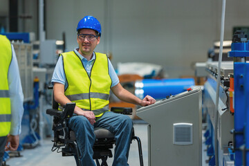 Production line engineer with disability in a factory with yellow vest and blue helmet at work.