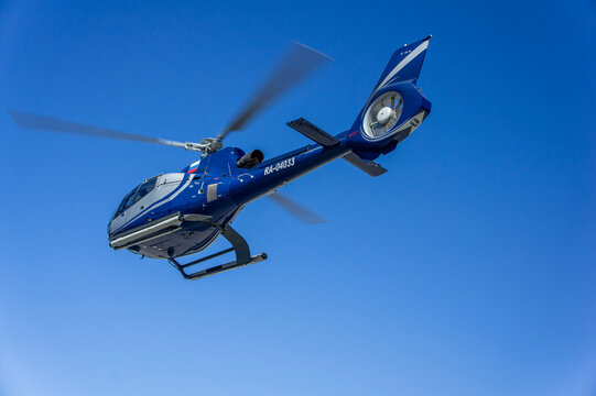 Hydroaviation Salon 2010 Single-engine light helicopter. Eurocopter EC130 B4 with one main rotor performs demonstration flight over Gelendzhik Bay. Gelendzhik, Russia - September 11, 2010