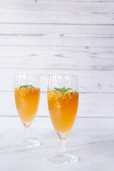 Kombucha second fermentation with passion fruit flavor. home-brew passion fruit flavor Kombucha in tall glasses on white table background..