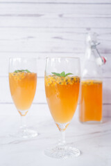 Kombucha second fermentation with passion fruit flavor. home-brew passion fruit flavor Kombucha in tall glasses on white table background..