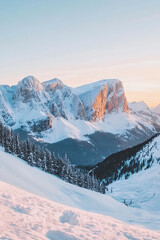 Fototapeta premium A serene scene of snow-covered mountains at sunset. The soft pink and golden hues of the setting sun create a magical atmosphere, lighting up the snowy landscape