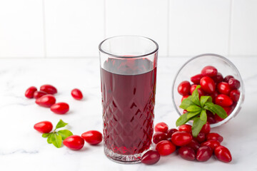 Glass of healthy dogwood berry drink on light background. Turkish name; Kizilcik serbeti