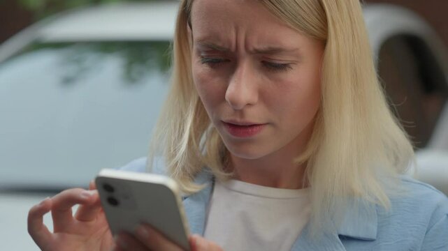 Worried Caucasian woman automobile driver female buyer swiping mobile phone screen anxious lady car problem transport breakdown fritz in city businesswoman girl searching auto repair service tow truck