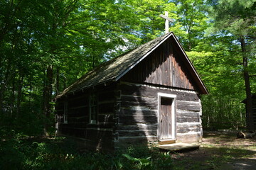 A log chapel built in a sparsely populated area in the forest in the late 18th century in Canada. It was used for religious services and other gatherings 