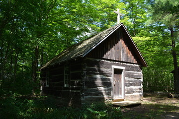 A log chapel built in a sparsely populated area in the forest in the late 18th century in Canada. It was used for religious services and other gatherings 
