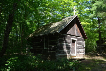 A log chapel built in a sparsely populated area in the forest in the late 18th century in Canada. It was used for religious services and other gatherings 