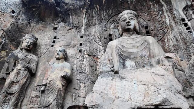 Luoyang Longmen, China: Panoramic footage of the famous statues and the Big Vairocana Buddha in the Longmen grottes Fengxian main cave that dates back from the 7th century in Central China.