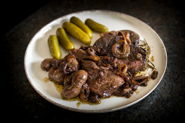 ready to eat - roasted innards from a reddeer calf with onions, rosemary, thyme, salt, pepper and pickles