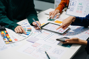  UX developer and ui designer brainstorming about mobile app interface wireframe design with...