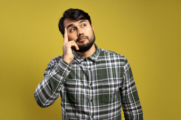 thoughtful man with finger on forehead