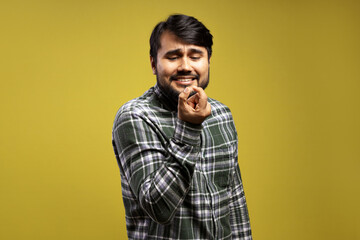 man looking at something small and smiling