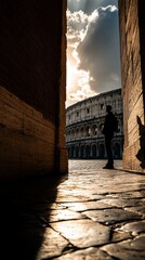 Tourist admiring the colosseum in rome at sunset from a stone corridor
