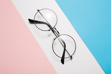 Eyeglasses with round rim for men or women lie diagonally.