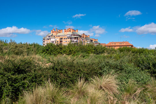 A vibrant residential complex with colorful architecture sits against a bright blue sky, symbolizing creativity, vibrancy, and harmonious living space in nature in Logrono Spain
