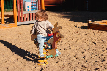 Fototapeta premium Little Toddler Playing At Playground Outdoors