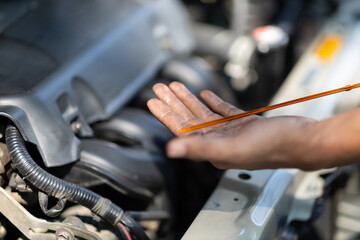 Obraz premium Auto mechanic checking engine and engine oil.