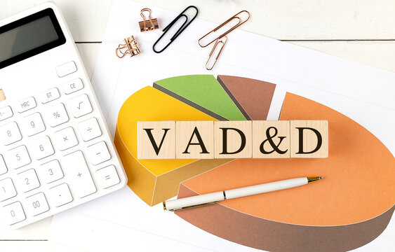  VAD and D Voluntary Accidental Death and Dismemberment concept with a wooden blocks, calculator, pie chart, and office supplies on a desk