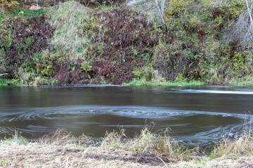 rapid flow of a wild river, blurred water surface, autumn in nature, Braslas river