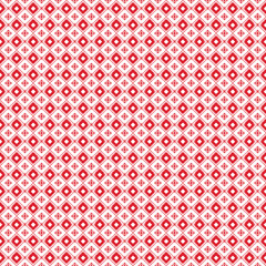 Red geometric pattern on a white background featuring symmetrical diamond shapes.