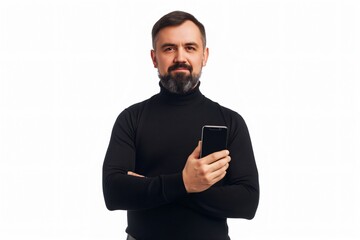 Middle aged man with a beard and a black turtleneck is holding a smartphone and crossing his arms